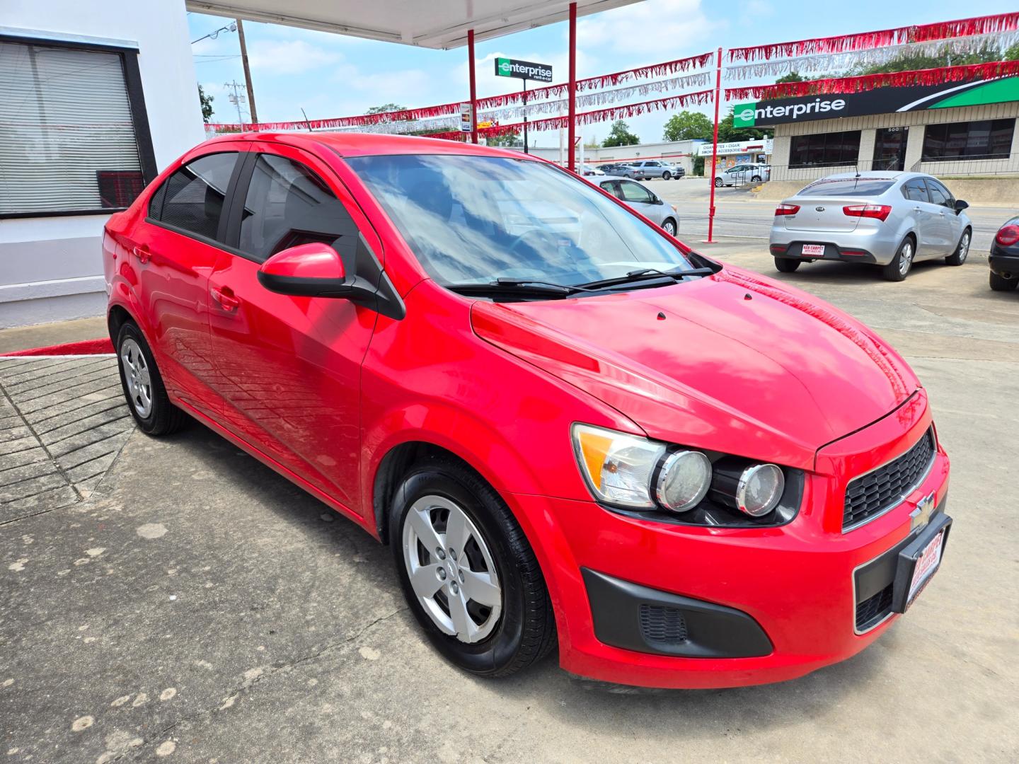 2015 Red /Black Chevrolet Sonic LS Auto Sedan (1G1JA5SH9F4) with an 1.8L L4 DOHC 24V engine, 6-Speed Automatic transmission, located at 503 West Court, Seguin, TX, 78155, (830) 379-3373, 29.568621, -97.969803 - Photo#1